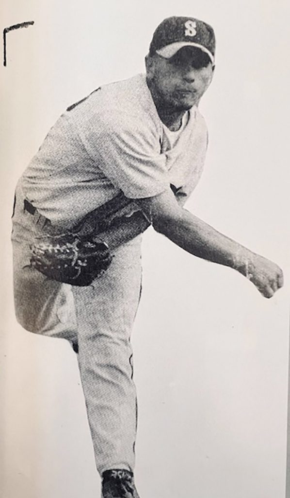 Photo of Nick Esopi from a newspaper with him pitching a baseball in a Stillwater uniform.